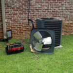 Air Conditioner compressor condenser coil with fan.
